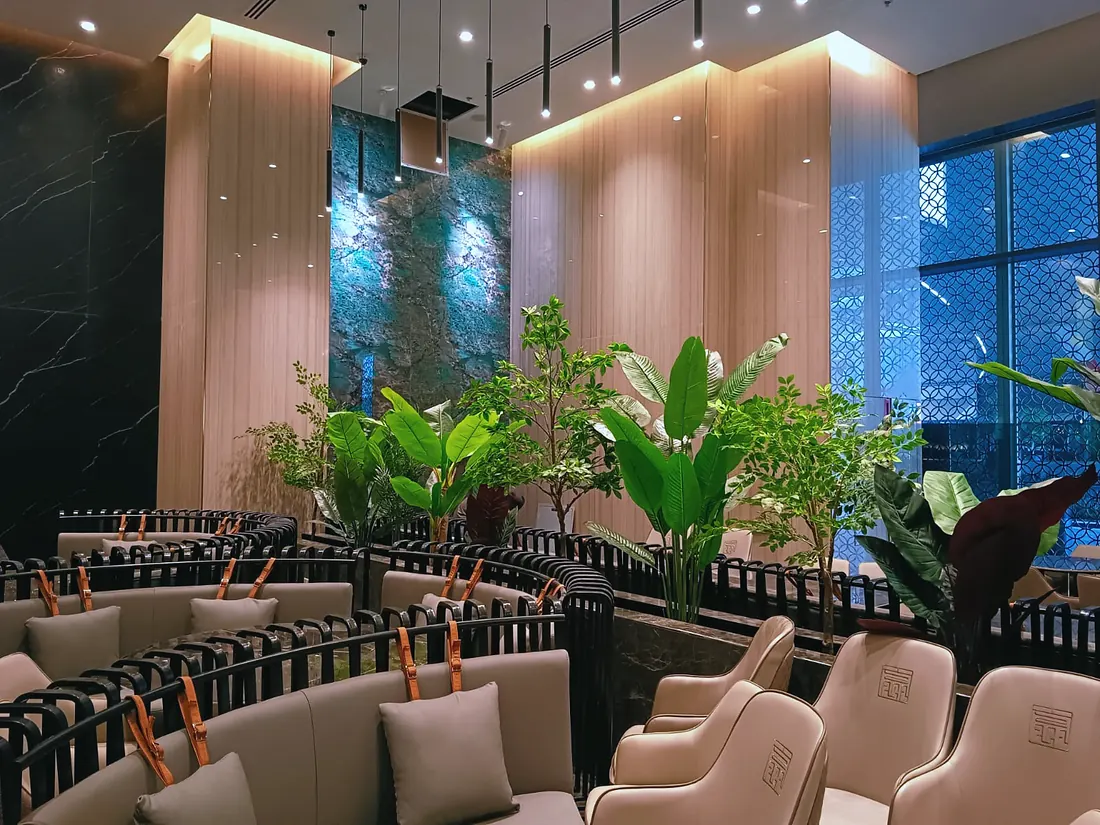 Chuan Xiao Guan restaurant, Dubai Mall: cane-back chairs, fluted timber wall and planting (frame 1 of 3)