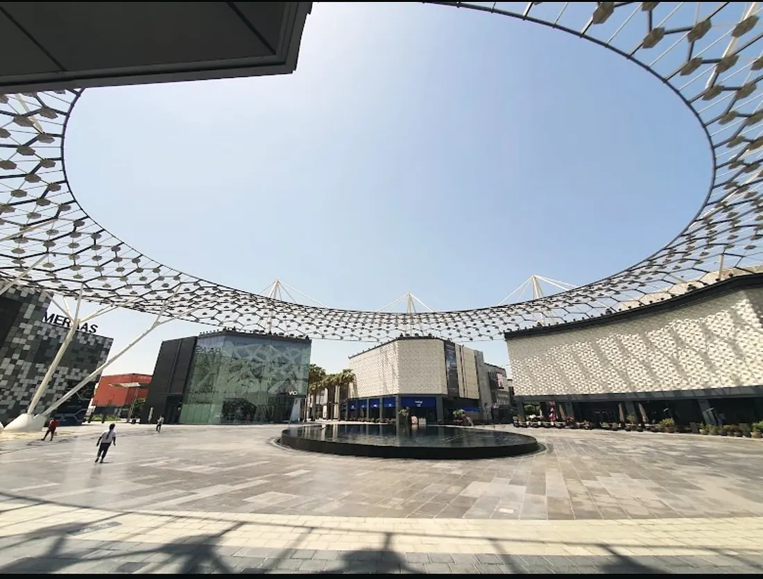 City Walk, Al Safa: the plaza paving under the lattice canopy (frame 1 of 3)
