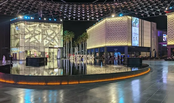 City Walk at night: fountain and paved plaza (frame 3 of 3)