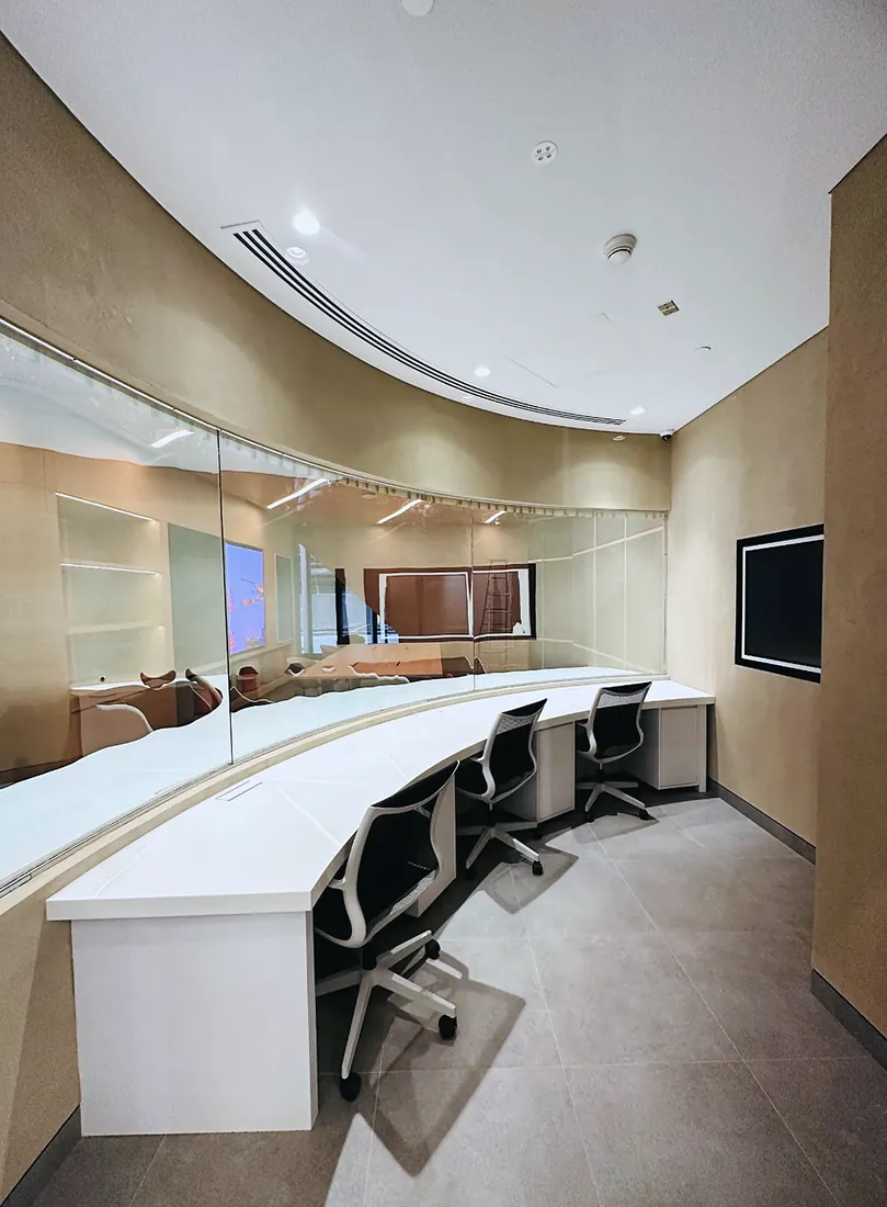 Mashreq Bank branch: curved consultation desks under a vaulted timber ceiling (frame 3 of 3)