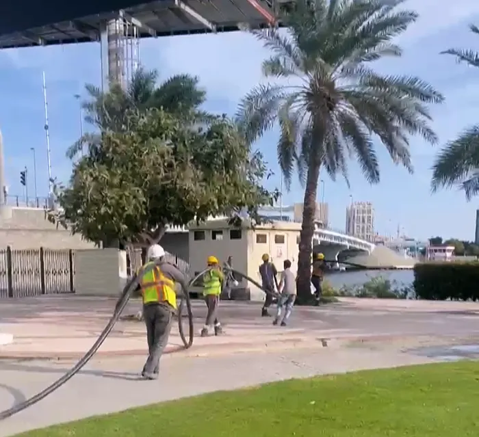 Site: the crew pulling cable to the LED wall (frame 3 of 3)